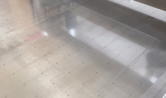 The heated squeegee coater coats the film with UV glue as shown in Figure 3