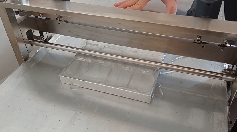 Scrape-coating of polymer materials on silicone molds for experimental small-scale coating machines